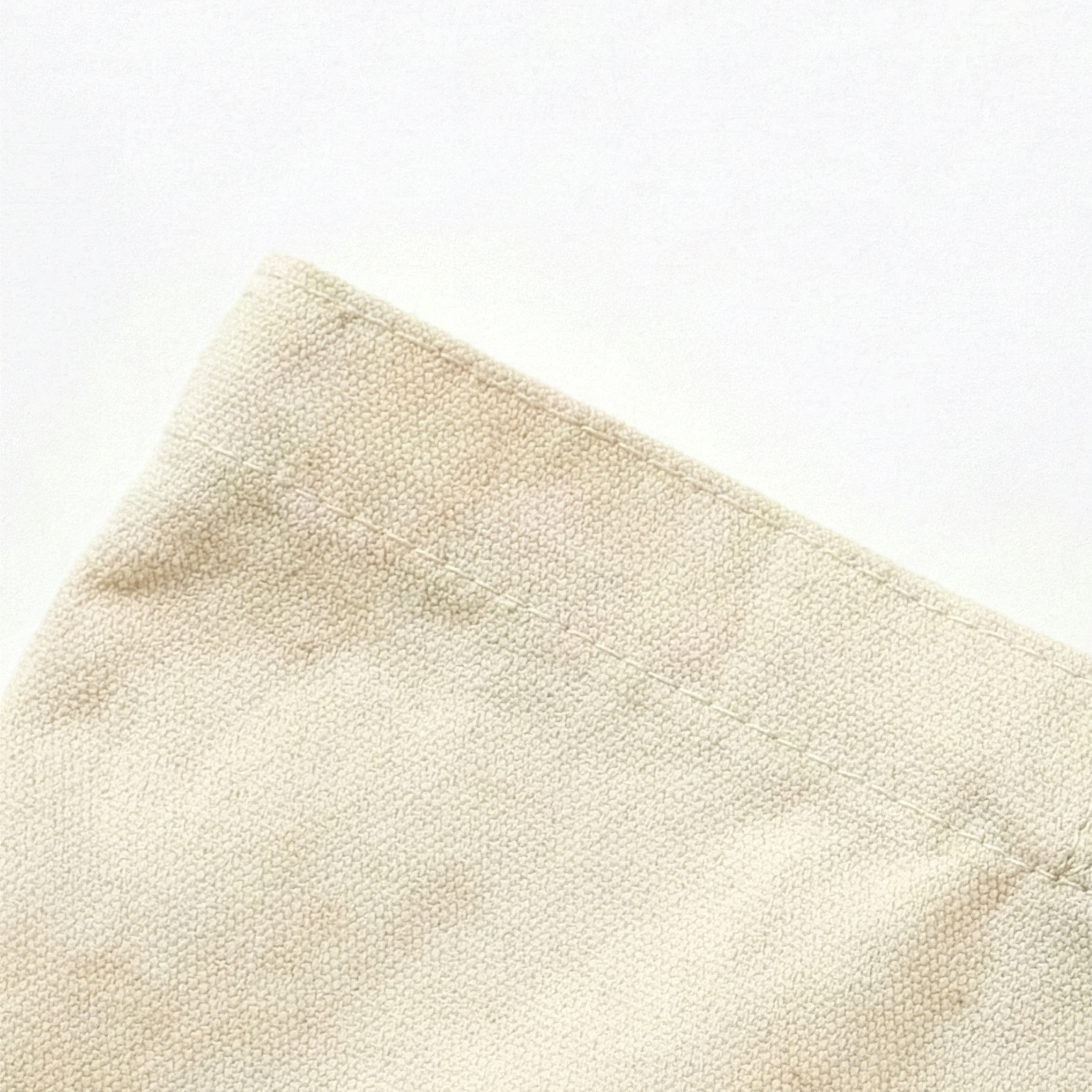 Close-up of beige fabric texture on a white background