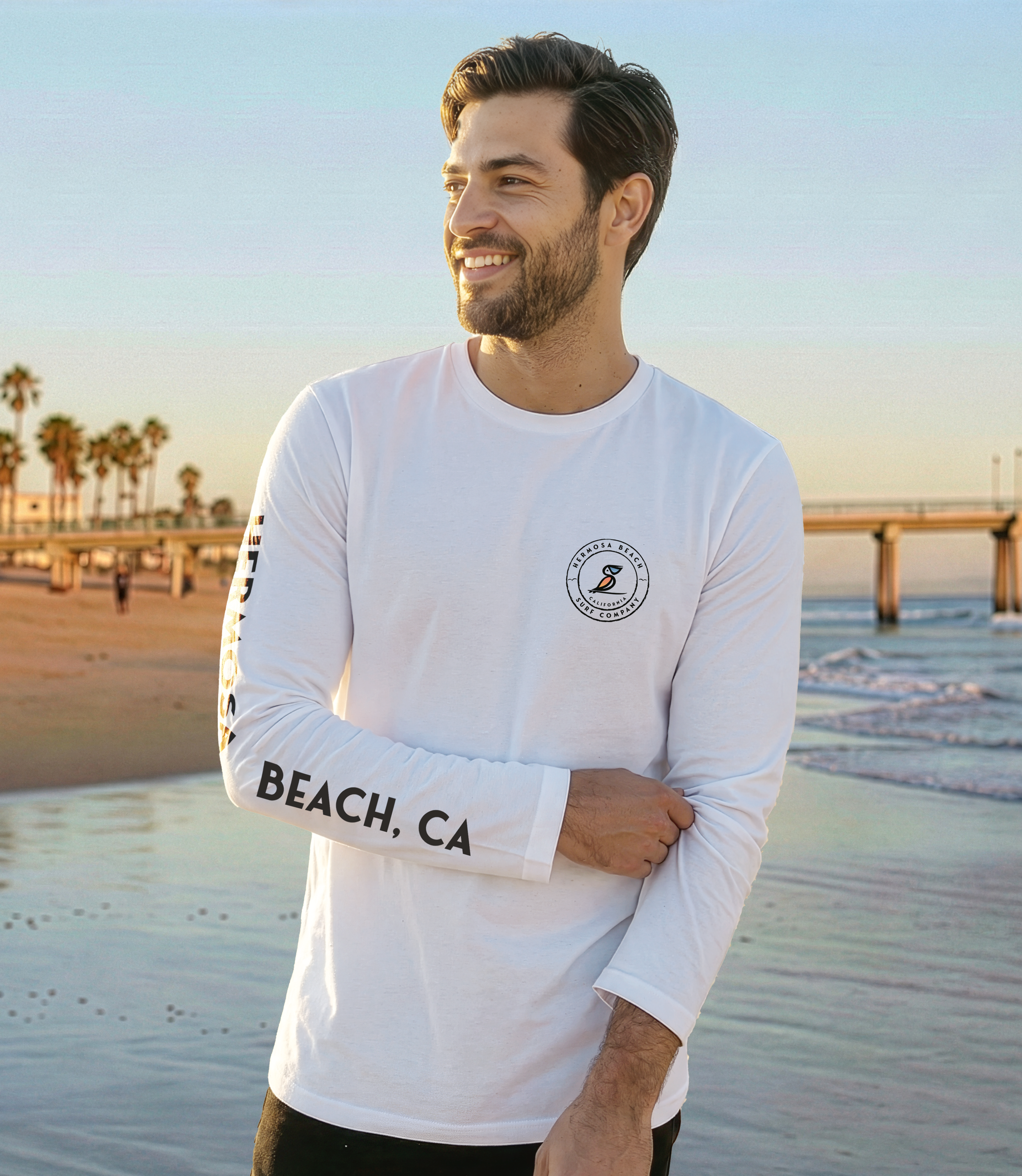 Man wearing a white long-sleeve shirt with 'Beach, CA' text on a beach background