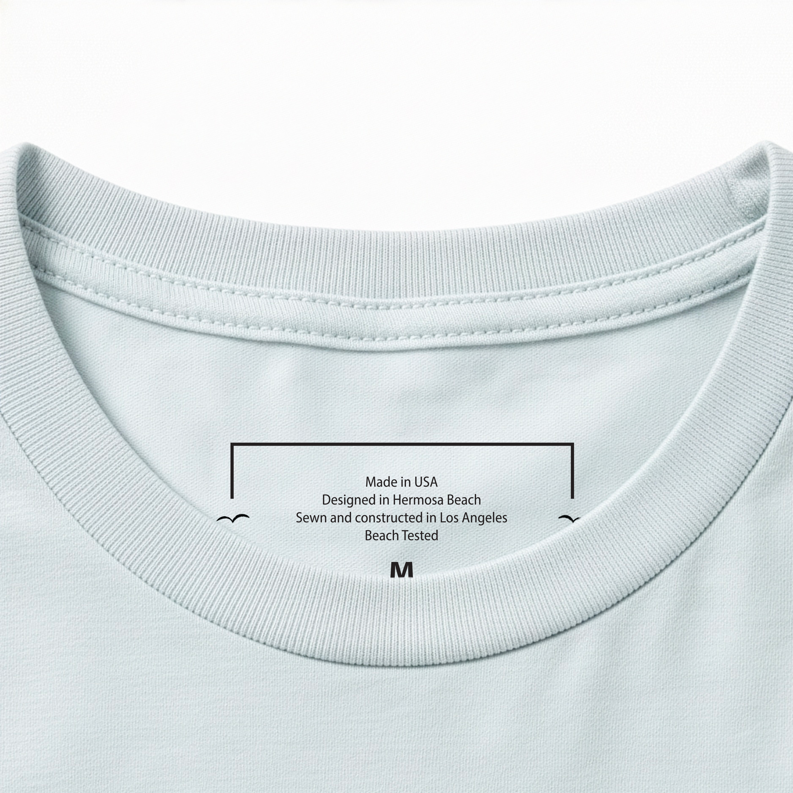 Close-up of a Dusty Blue t-shirt collar with text on a white background