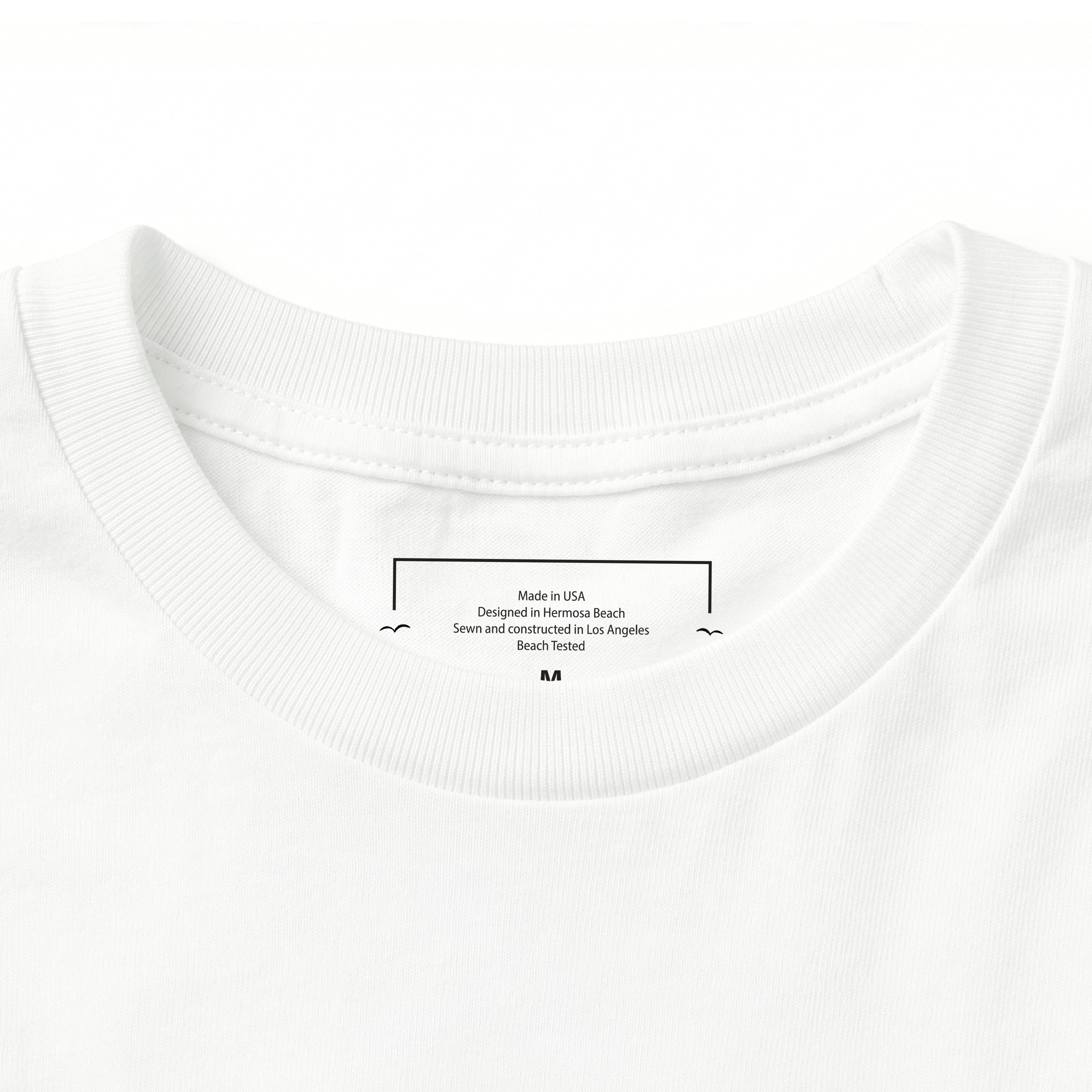 Close-up of a white t-shirt with a label on the collar.