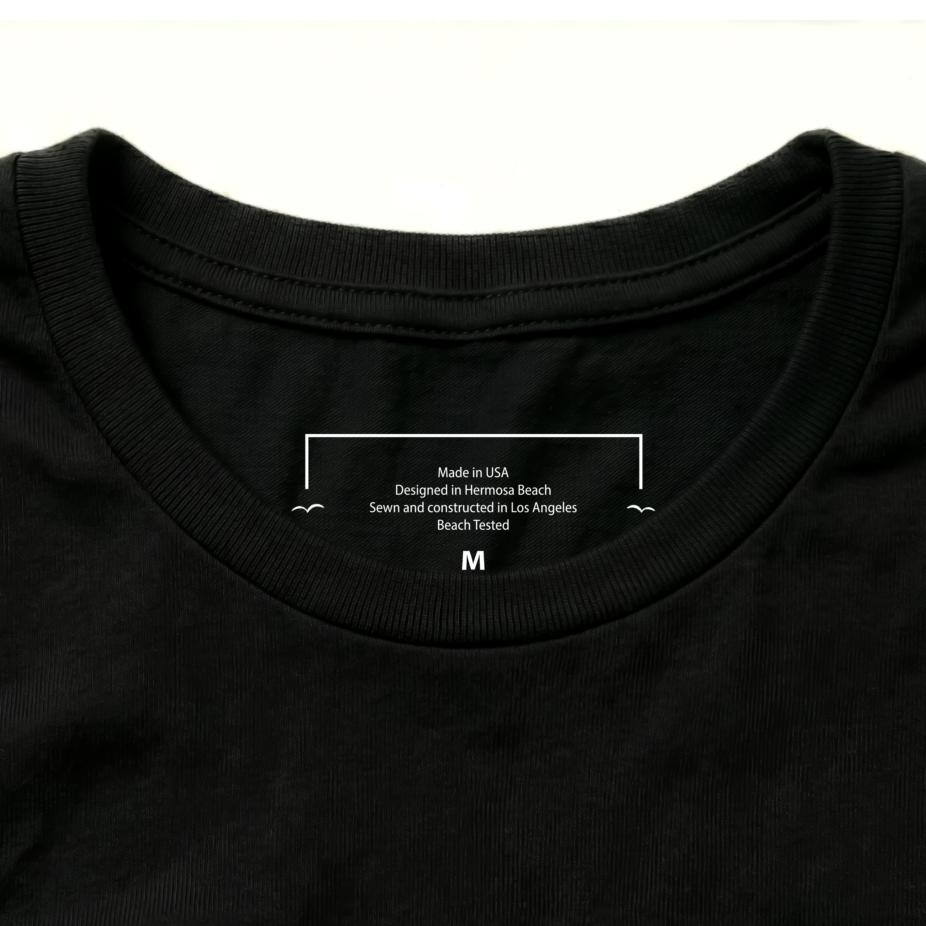 Black t-shirt with white text on the collar