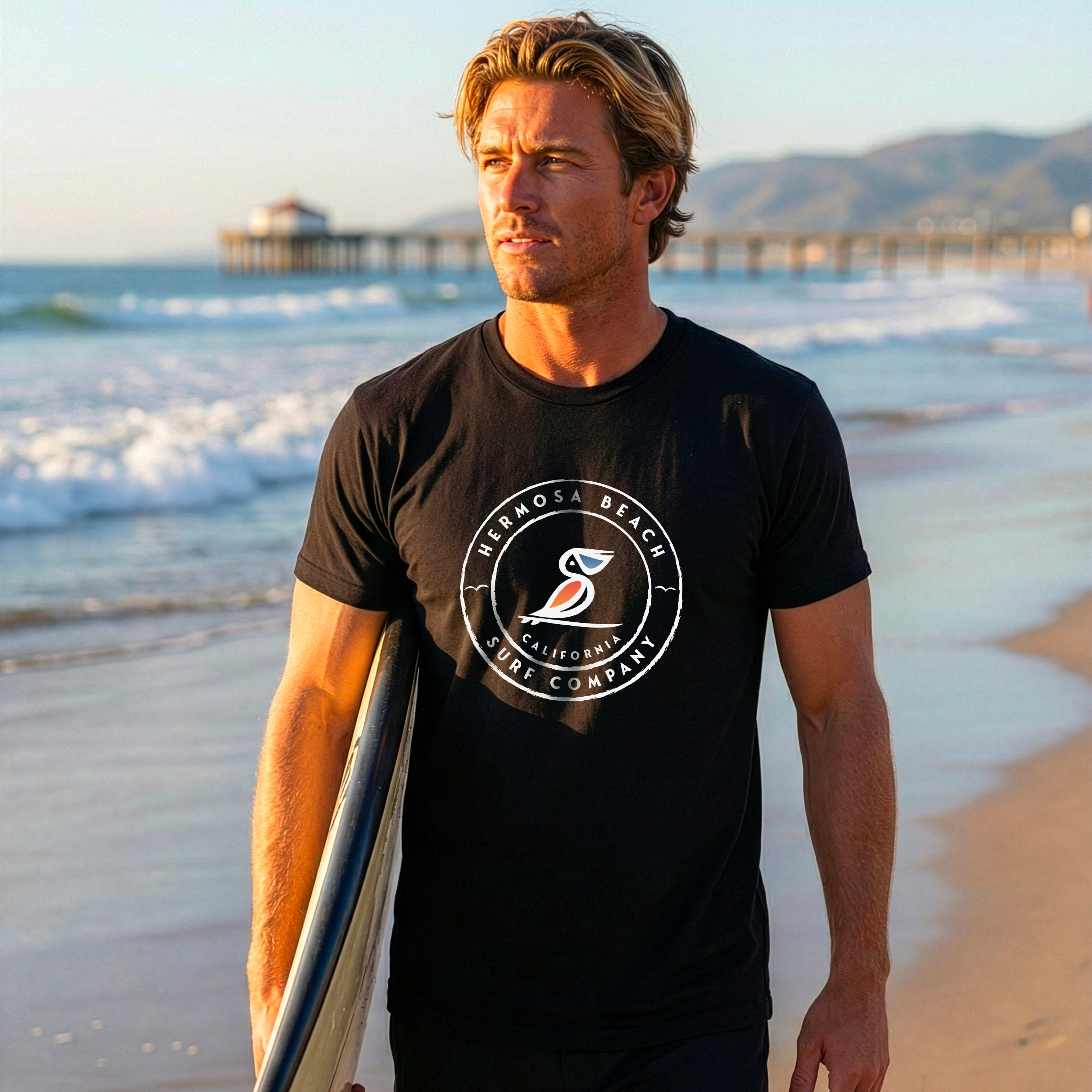 Man holding a surfboard on a beach with a scenic background