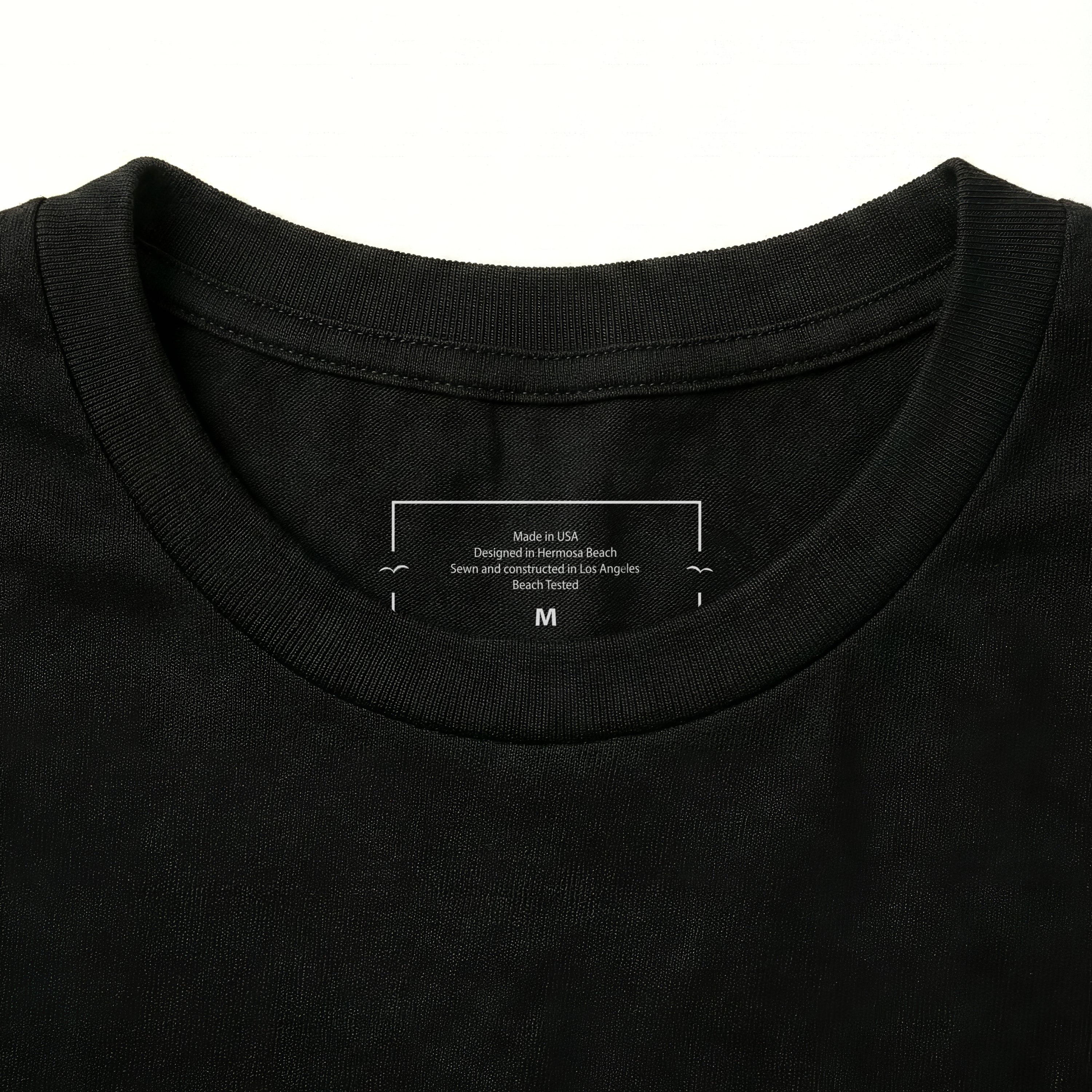 Black t-shirt collar with a label on a white background