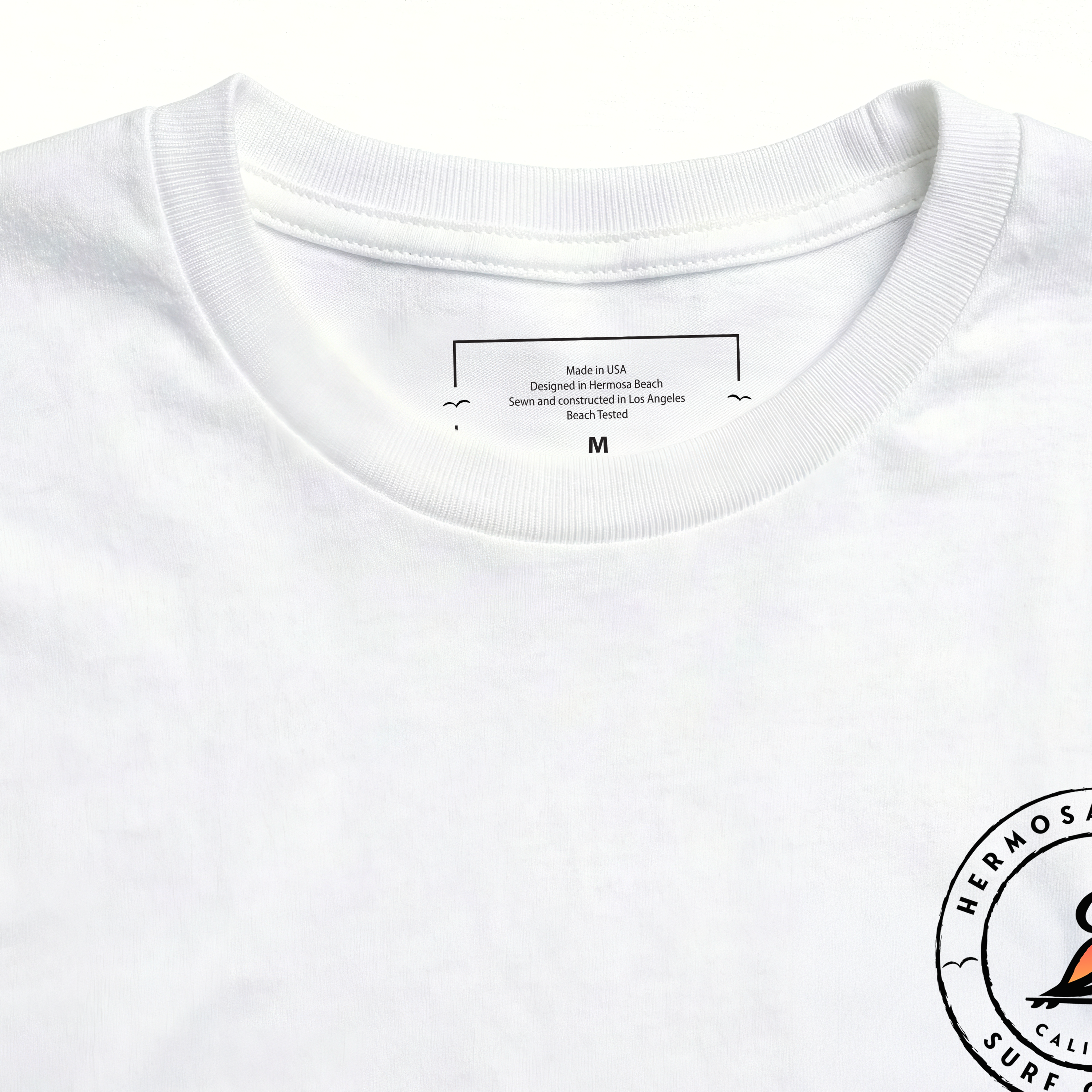 Close-up of a white shirt with a label and logo on a white background