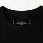 Close-up of a black t-shirt with a label on the collar.