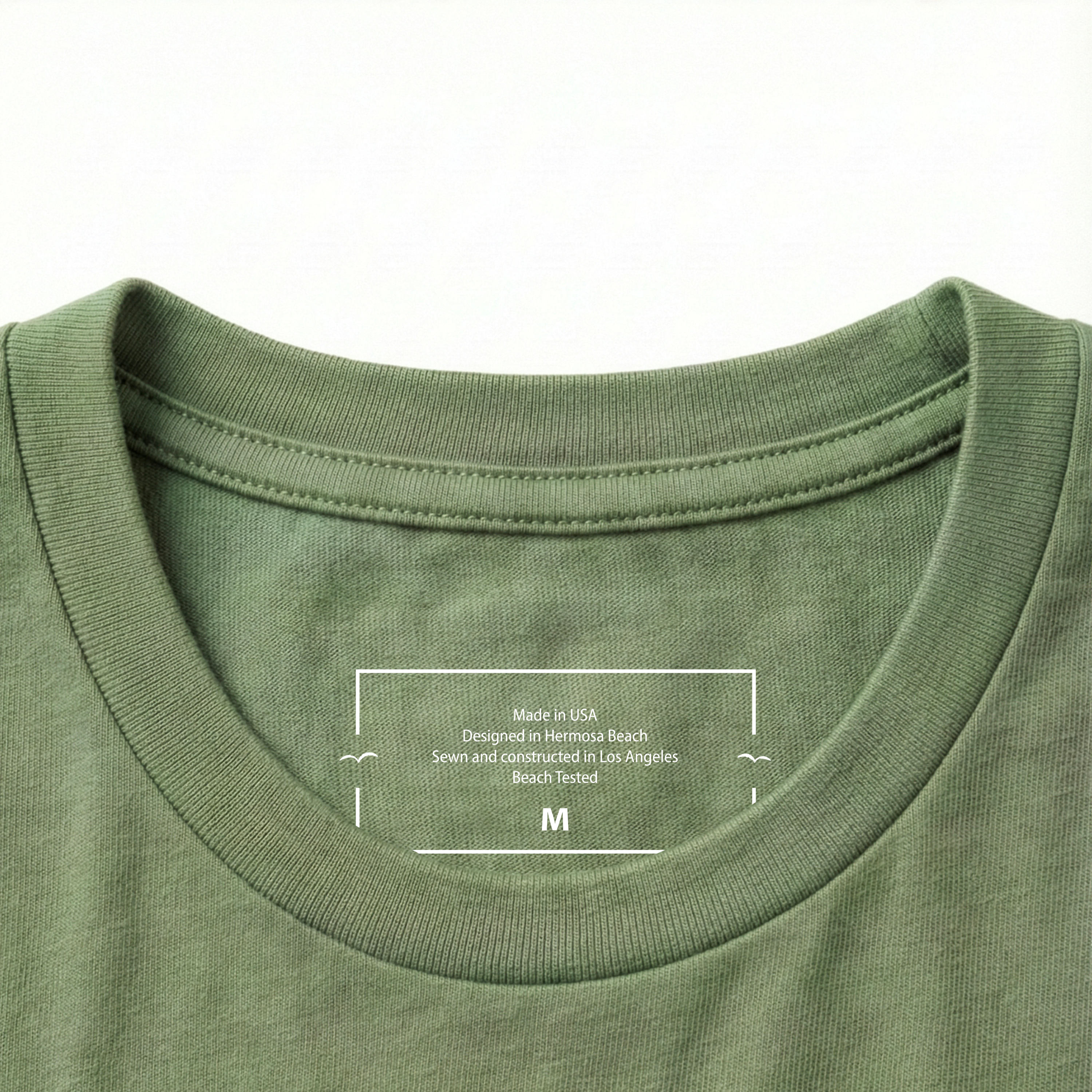 Close-up of a Olive green t-shirt collar with a label on a white background