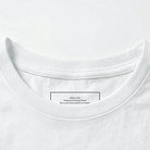Close-up of a white t-shirt collar with a label on a white background