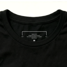 Black t-shirt with white text on the collar