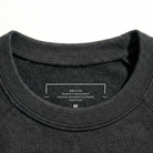 Close-up of a Grey sweatshirt collar with a label on a white background
